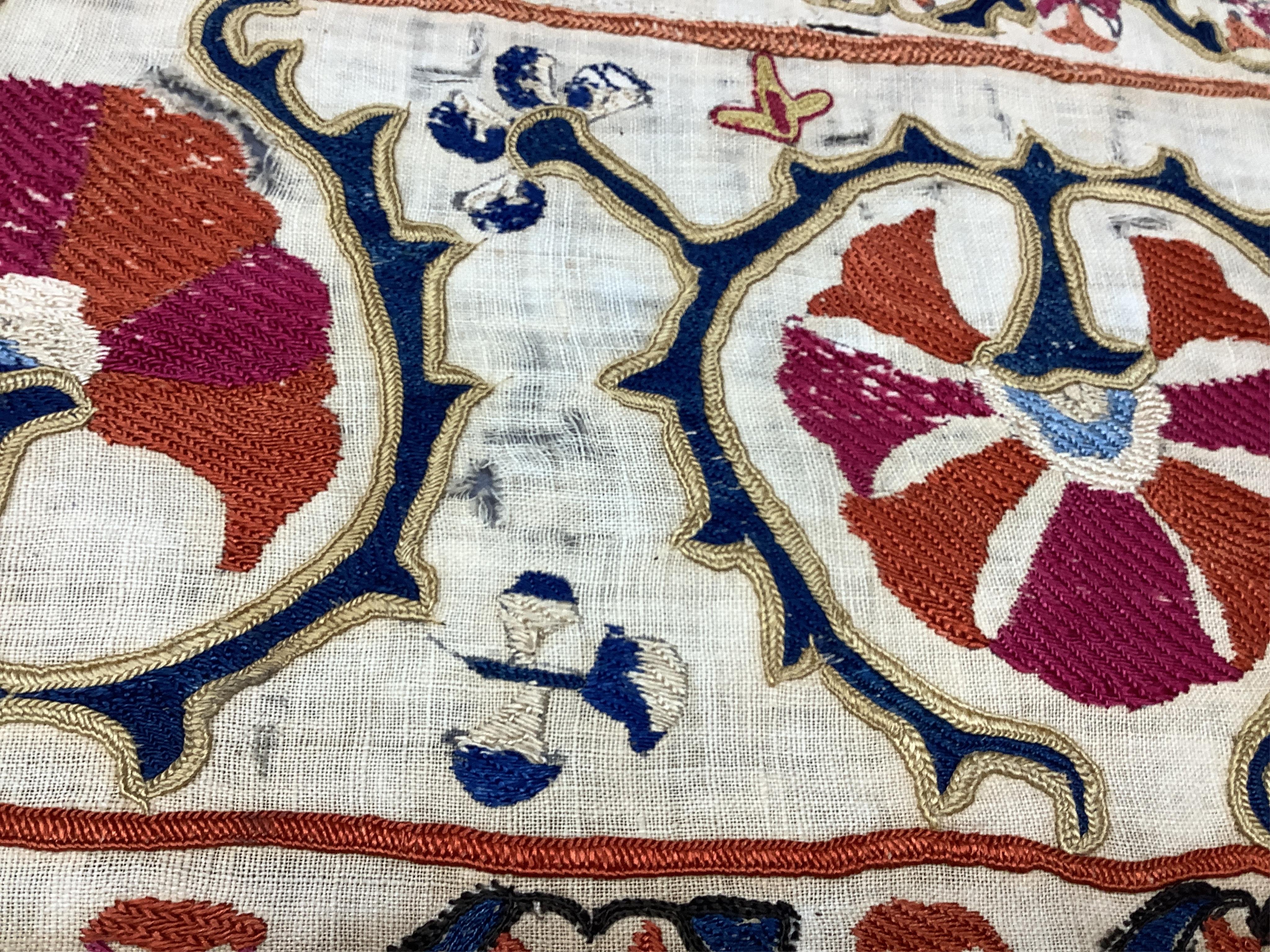 A 19th century Uzbekistan Suzani, hand embroidered hanging. Made from hand woven linen panels each approximately 28cm wide x 167cm long. Hand embroidered with silk hand dyed threads, in orange, red, blue and yellows, usi
